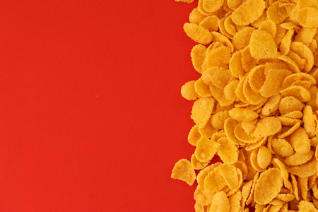 Background of breakfast cereals in big amount on red background close up, top viewの写真素材