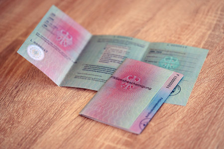 German temporary Permanent resident card specimen lies on wooden table close up. Fiktionsbescheinigungの写真素材