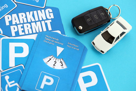Parking permit paper notice tag and parking disc with ignition keys and car. Parking permit for...