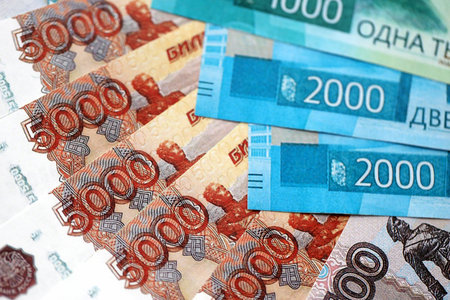Russian ruble money bills banknotes lies in big pile on table close up. Concept of finances and...