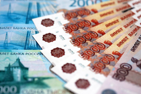 Russian ruble money bills banknotes lies in big pile on table close up. Concept of finances and...