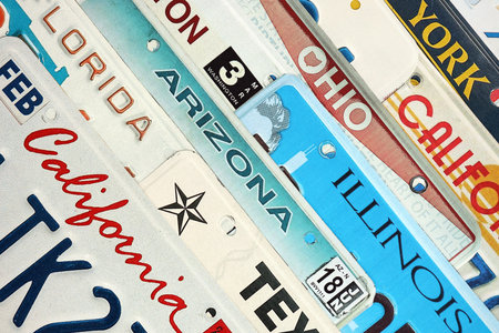 Old US car license plates with various state names. Concept of driving in United States.の写真素材