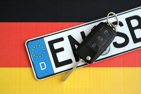 Germany Deutschland car license plate and key on german flag close up. Driving permit and registration conceptの写真素材