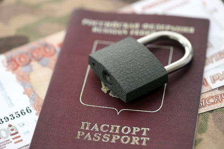 Russian rubles money bills and passport under ban of heavy lockpad close up. Concept of sanctions and restrictions to russian citizensの写真素材