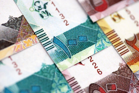 Qatari riyal money bills banknotes lies in big pile on table close up. Concept of finances and business in Qatarの写真素材