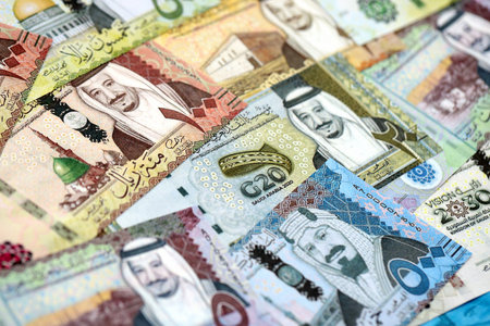 Saudi Arabia riyal money bills banknotes lies in big pile on table close up. Concept of finances and business in Saudi Arabiaの写真素材