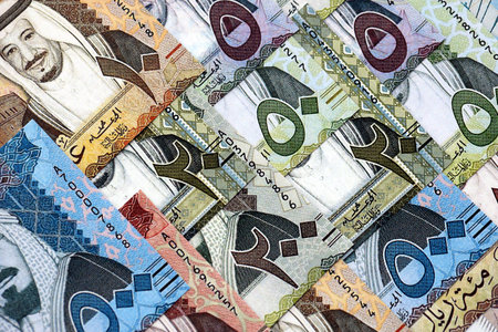 Saudi Arabia riyal money bills banknotes lies in big pile on table close up. Concept of finances and business in Saudi Arabiaの写真素材