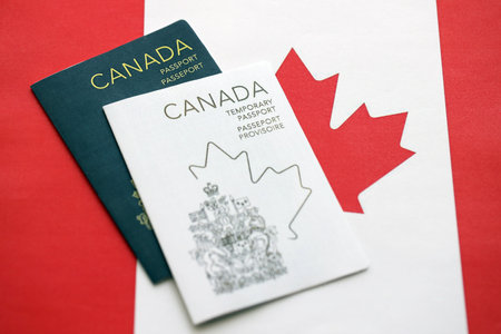 Canadian temporary and permanent passports lies on flag close upの写真素材