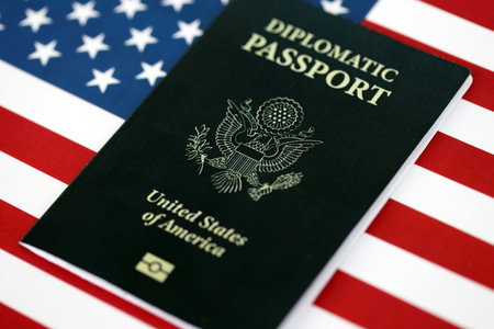 United States diplomatic passport book on US flag close up. Travel document on official banner photoの写真素材
