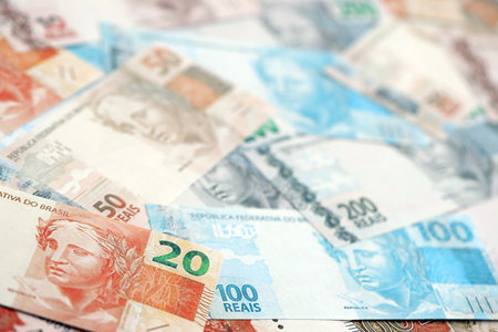 Brazilian reais banknotes. The current Brazil real money bills lies on table in big amount. The...