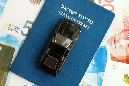Israel New Shekels banknotes and toy car with passport. The current Israel money bills and black car with pass lies on table in big amount. The concept of car ownership in Israelの写真素材