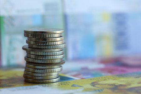Swiss franc banknotes and coins. The current francs money bills and coins lies on table in big...