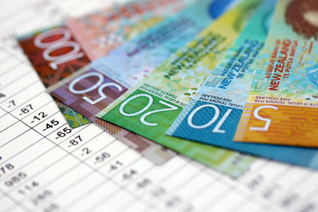 New Zealand dollars money bills banknotes on document with business calculations table close up. Business, investment and taxation in New Zealandの写真素材