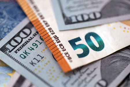 One hundred US dollar bill banknotes and fifty european Euro currency banknote. Concept of currency exchange between USD and EURの写真素材