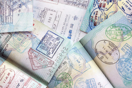 Many open passport pages with lots of visas and entrance stamps from various countries passport...