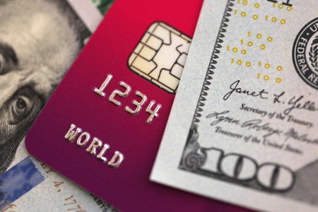 One hundred US dollar bill banknote on purple credit card for banking and payments. Concept of...
