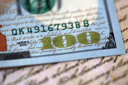 One hundred US dollar bills and United States Constitution page fragment. Concept of lawsuit in United Statesの写真素材