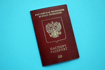 Russian Federation red passport on light blue table background close up. Concept of travel and tourismの写真素材