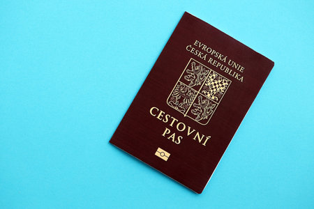 Czech biometrical passport on blue table background. Concept of citizenship of Czech Republicの写真素材