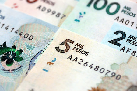 Colombian pesos money bills banknotes lies in big pile on table close up. Concept of finances and business in Colombiaの写真素材