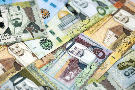 Saudi Arabia riyal money bills banknotes lies in big pile on table close up. Concept of finances and business in Saudi Arabiaの写真素材