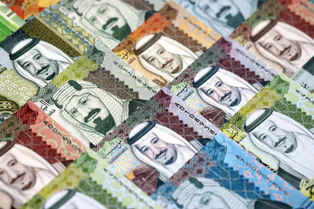 Saudi Arabia riyal money bills banknotes lies in big pile on table close up. Concept of finances and business in Saudi Arabiaの写真素材