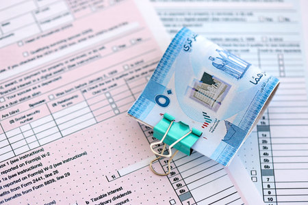 United Arab Emirates dirham money bills on tax form close up. Taxation and accounting conceptの写真素材