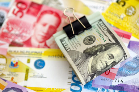 Philippines peso currency money bills and bunch of us dollar banknotes close up. The concept of economics and currency exchangeの写真素材