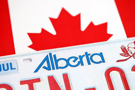 Alberta canadian car license plate on flag of Canada close up. Driving permit and registration conceptの写真素材