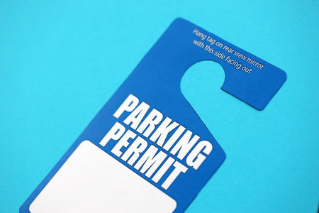 Parking permit paper notice tag for car interior close up. Parking permit for people with disabilities concept.の写真素材