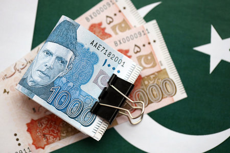 Pakistan rupees banknotes on Pakistani flag. The current Pakistan money bills lies on banner in big amount. The concept of economics and business in Pakistanの写真素材
