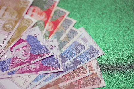 Pakistan rupees banknotes on glitter green background. The current Pakistan money bills lies on table in big amount. The concept of business and investment in Pakistanの写真素材