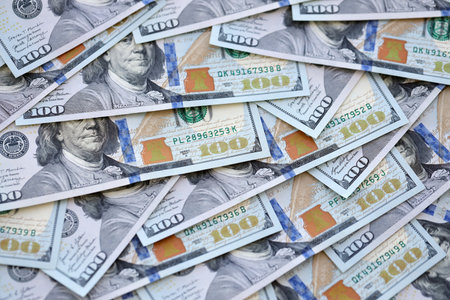 Many one hundred dollars money bills banknotes on smooth surface close up. Concept of business, rich life and economical questions in United States of America and around the worldの写真素材