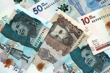 Colombian pesos money bills banknotes lies in big pile on table close up. Concept of finances and business in Colombiaの写真素材
