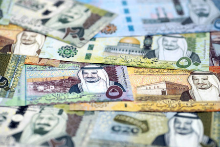 Saudi Arabia riyal money bills banknotes lies in big pile on table close up. Concept of finances and business in Saudi Arabiaの写真素材