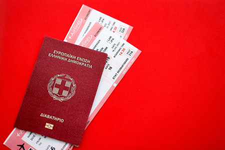 Greece passport and commercial airlines boarding pass tickets close up. Travel flights and avia tourism in Europe conceptの写真素材