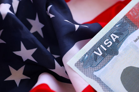 VISA to the USA and the flag of the United States of America. Work and travel documents for visiting the USA. Visa for immigrationの写真素材