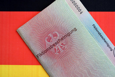 German temporary Permanent resident card specimen lies on Germany flag close up. Fiktionsbescheinigungの写真素材
