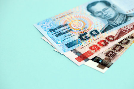 Thai baht money bills in big amount on blue close up. Finance and banking conceptの写真素材