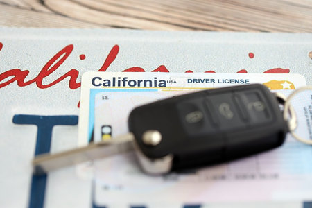Remote control car keys on license plate with driver license. Concept of driving in California. Reaching a driving permitの写真素材