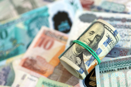 Egyptian pound currency money bills and bunch of us dollar banknotes close up. The concept of economics and currency exchangeの写真素材