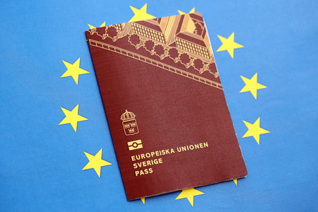 Swedish biometrical passport on European Union flag background. Concept of citizenship of Swedenの写真素材