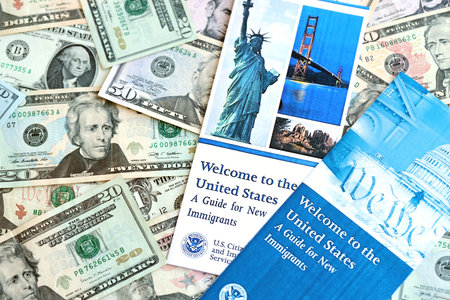 KYIV, UKRAINE - AUGUST 31, 2025 Permanent resident green card holders guide for new immigrants lies on many dollar bills close upのeditorial素材