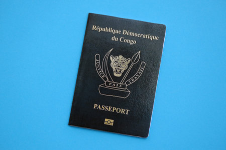 Democratic Republic of Congo black passport on light blue table background close up. Concept of travel and tourismの写真素材