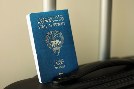 Kuwaiti passport on travel luggage close up. The concept of travel and vacationの写真素材
