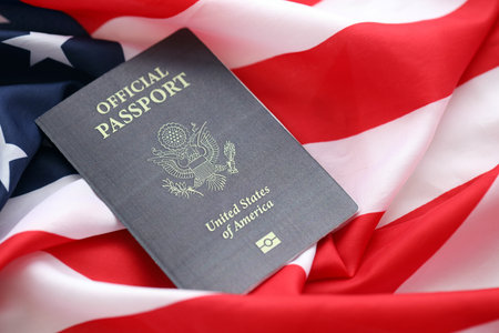 United States official passport book on US flag close up. Travel document on official banner photo