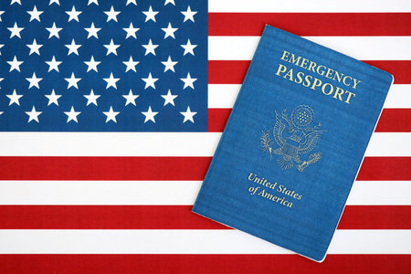 United States emergency passport book on US flag close up. Travel document on official banner photoの写真素材