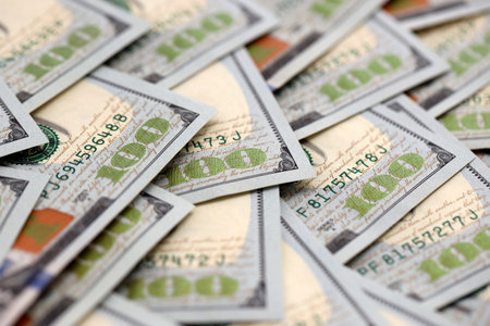 United States Dollar currency money bills. USD currency banknotes in big amount with different...
