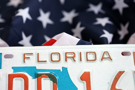 USA state of Florida license plate on US flag. Concept of driving in Florida. Reaching a driving permitの写真素材