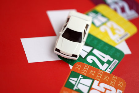 Switzerland vignette stickers for different years with toy car on Swiss flag close up. Driving permit and registration conceptの写真素材